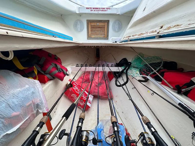 Slide: The Image of Interior of 1988 Ocean Master 31 Center Console with fishing gear and life jackets. - 19