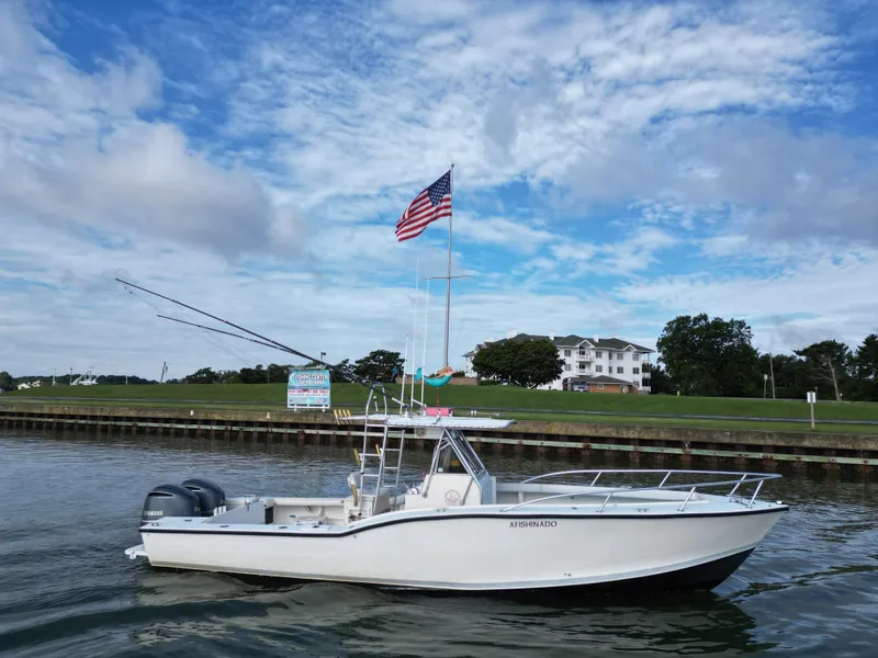 Slide: The Image of 1988 Ocean Master 31 Center Console boat on calm water with American flag. - 5