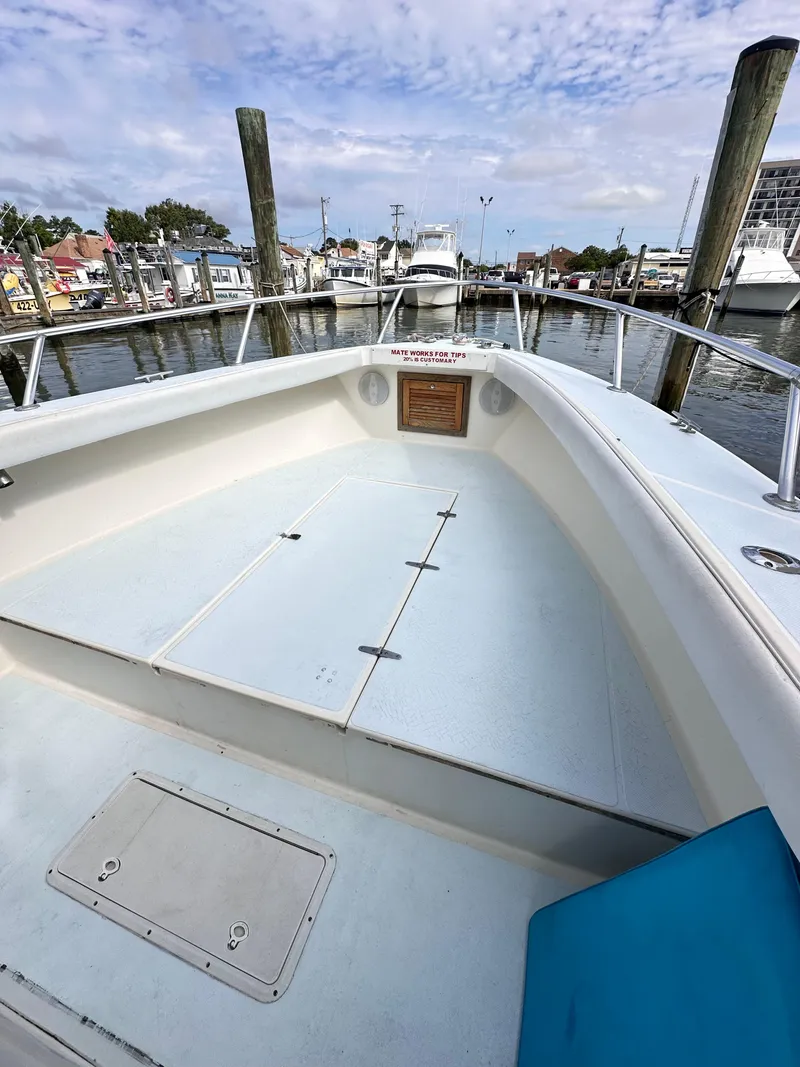 Slide: The Image of 1988 Ocean Master 31 Center Console boat docked at a marina. - 23