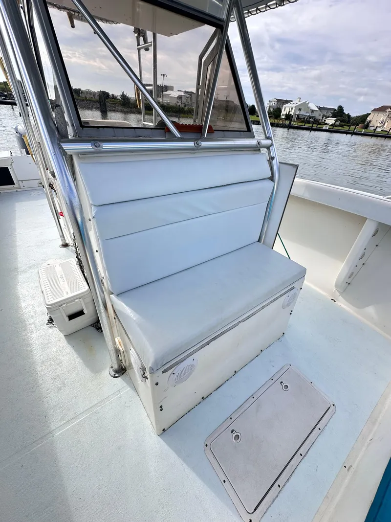 Slide: The Image of 1988 Ocean Master 31 Center Console boat with cushioned seating and waterfront view. - 29