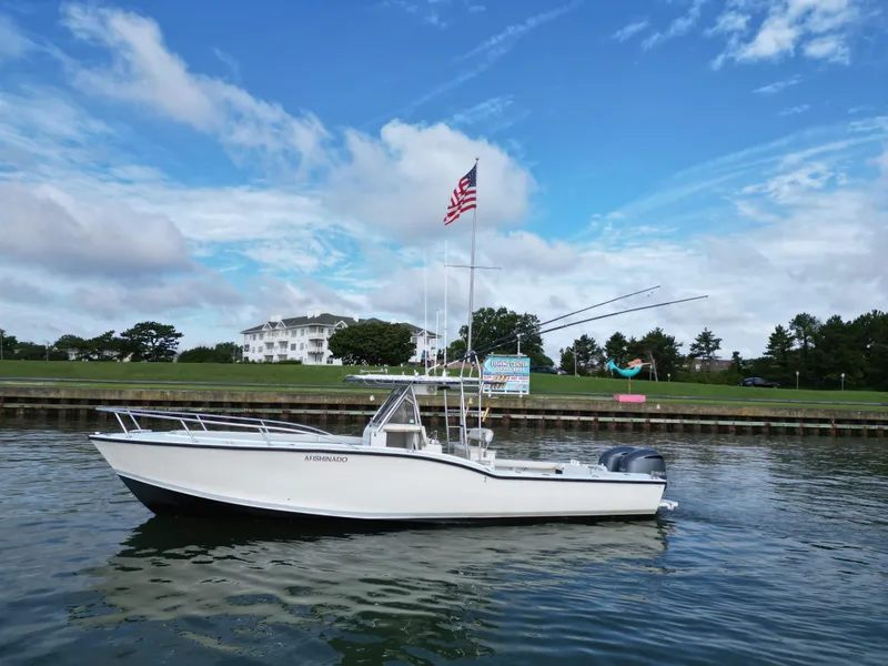 The Image of 1988 Ocean Master 31 Center Console boat on calm water with American flag. - 0