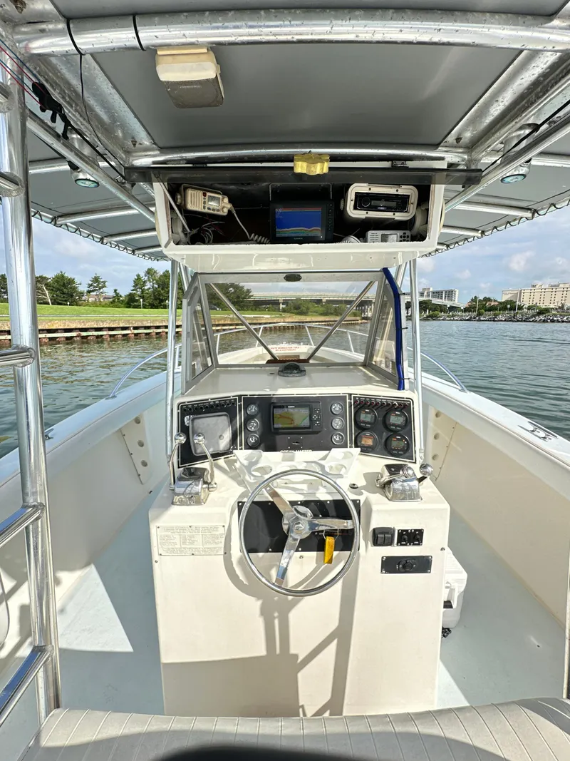 Slide: The Image of 1988 Ocean Master 31 Center Console boat interior with steering wheel and control panel. - 8