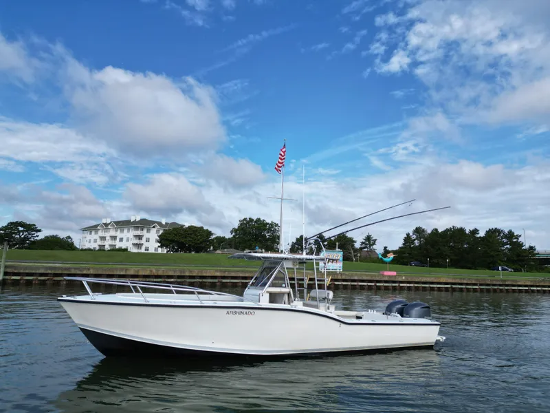 Slide: The Image of 1988 Ocean Master 31 Center Console boat on calm water with blue sky background. - 3