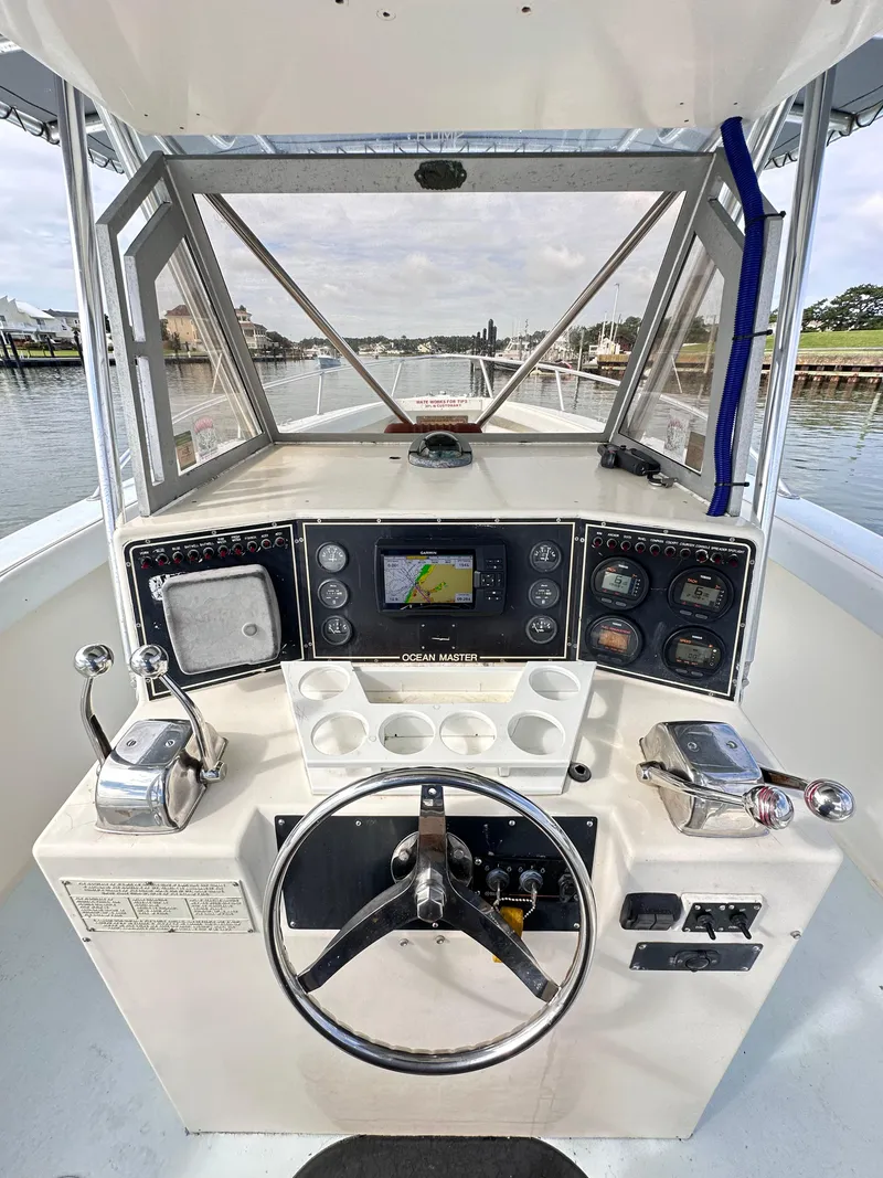Slide: The Image of 1988 Ocean Master 31 Center Console boat helm with navigation equipment and controls. - 7