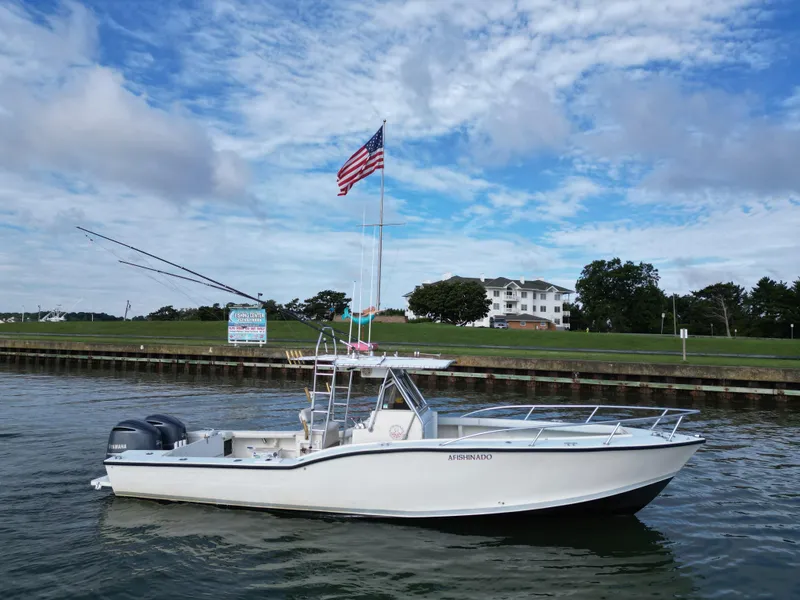 Slide: The Image of 1988 Ocean Master 31 Center Console boat on calm water with American flag. - 6