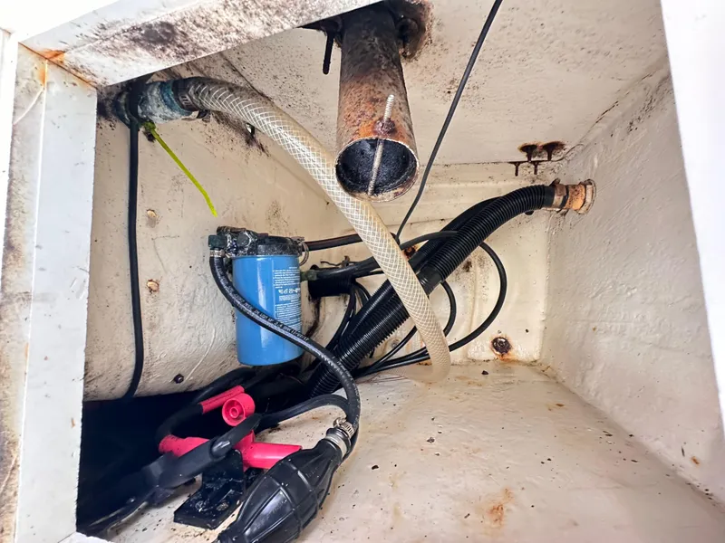 Slide: The Image of 1988 Ocean Master 31 Center Console bilge area with hoses and wiring. - 27