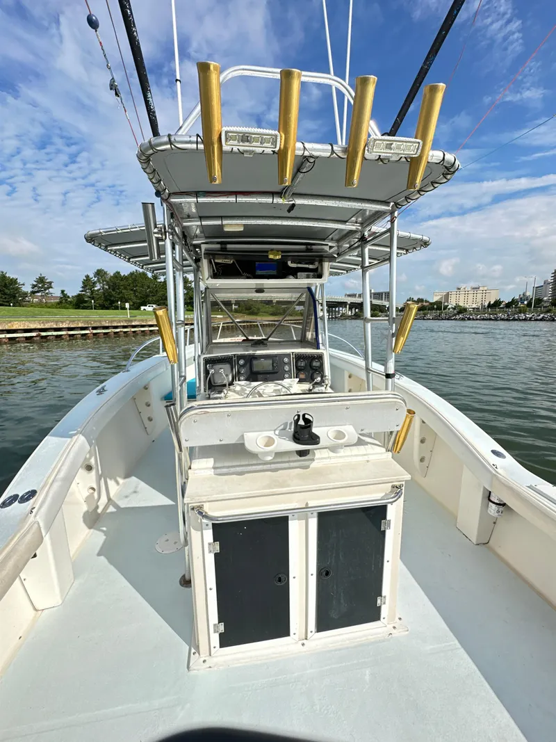 Slide: The Image of 1988 Ocean Master 31 Center Console boat on water, featuring fishing rod holders and navigation equipment. - 14