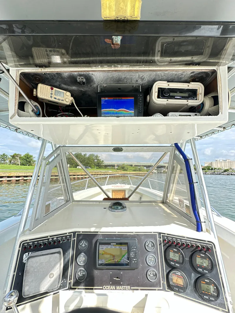 Slide: The Image of 1988 Ocean Master 31 Center Console boat dashboard with navigation and communication equipment. - 9