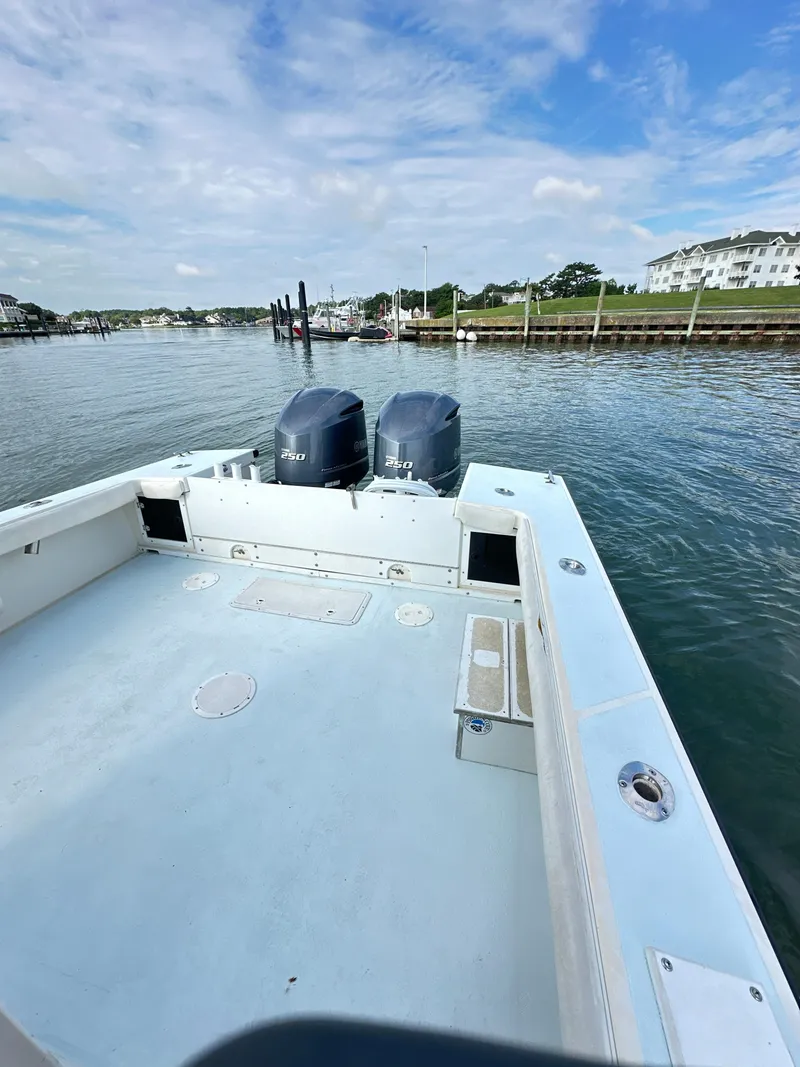 Slide: The Image of 1988 Ocean Master 31 Center Console boat on calm waters with twin outboard motors. - 17