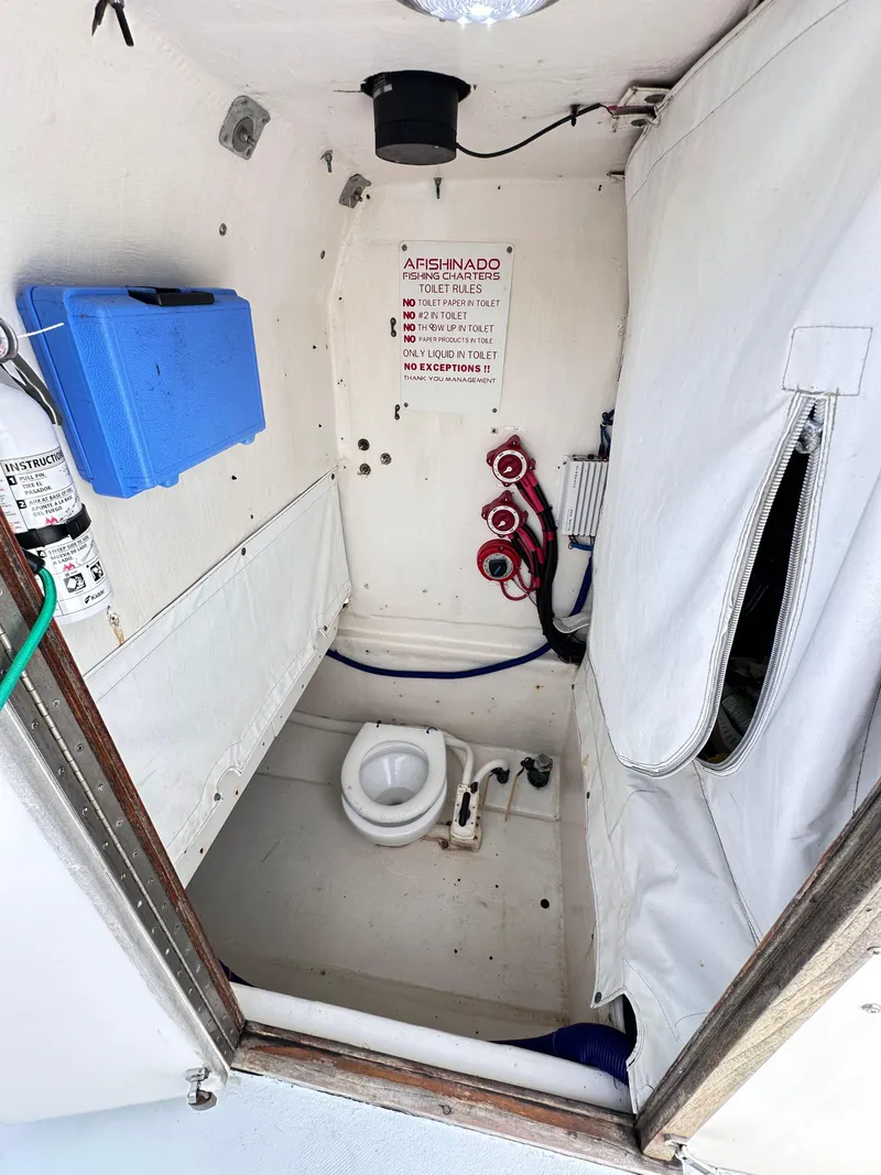 Slide: The Image of 1988 Ocean Master 31 Center Console boat interior with marine toilet. - 25
