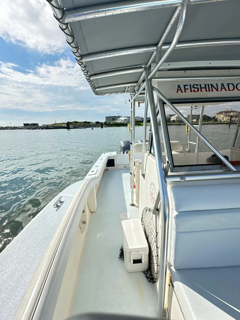 Slide: The Image of 1988 Ocean Master 31 Center Console boat docked by the water. - 33