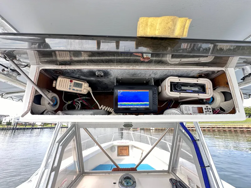 Slide: The Image of 1988 Ocean Master 31 Center Console boat dashboard with navigation and communication equipment. - 10