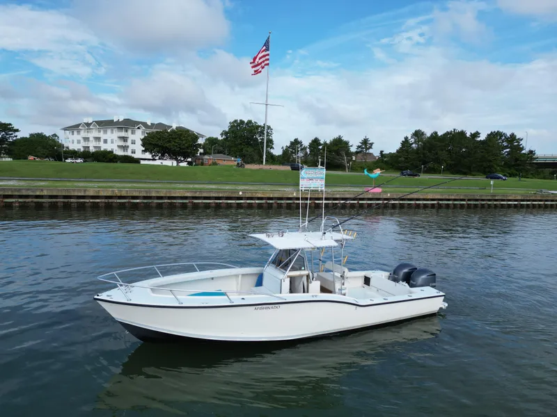 Slide: The Image of 1988 Ocean Master 31 Center Console boat on calm water with American flag in background. - 2