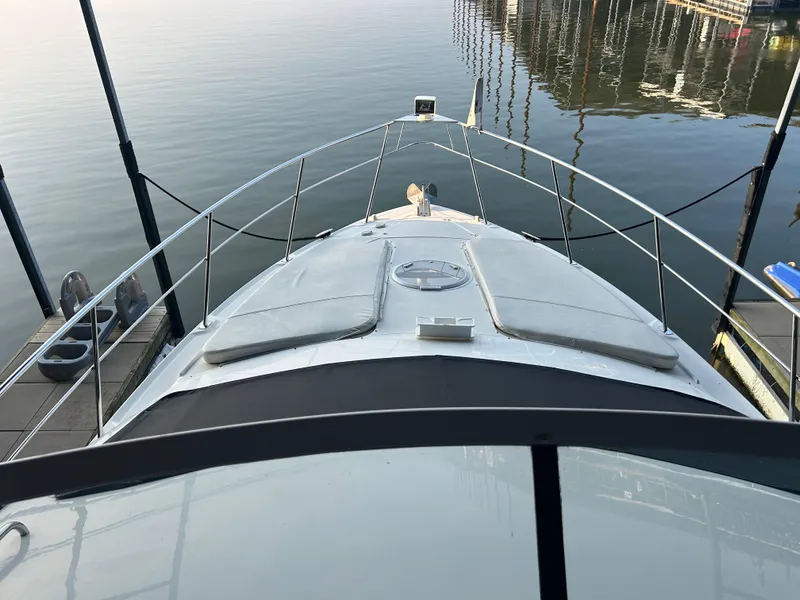 Slide: The Image of 2008 Cruisers 395 Motoryacht docked, view from bow, calm water background. - 12