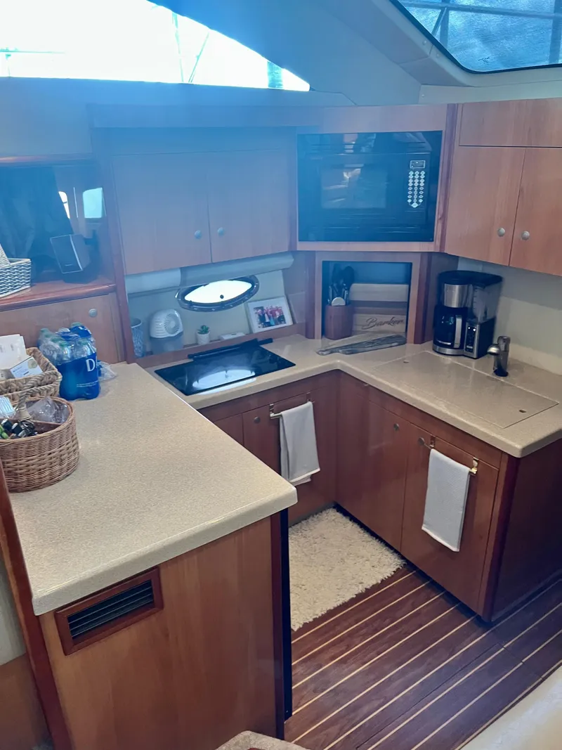 Slide: The Image of 2008 Cruisers 395 Motoryacht kitchen with wood cabinetry and modern appliances. - 16