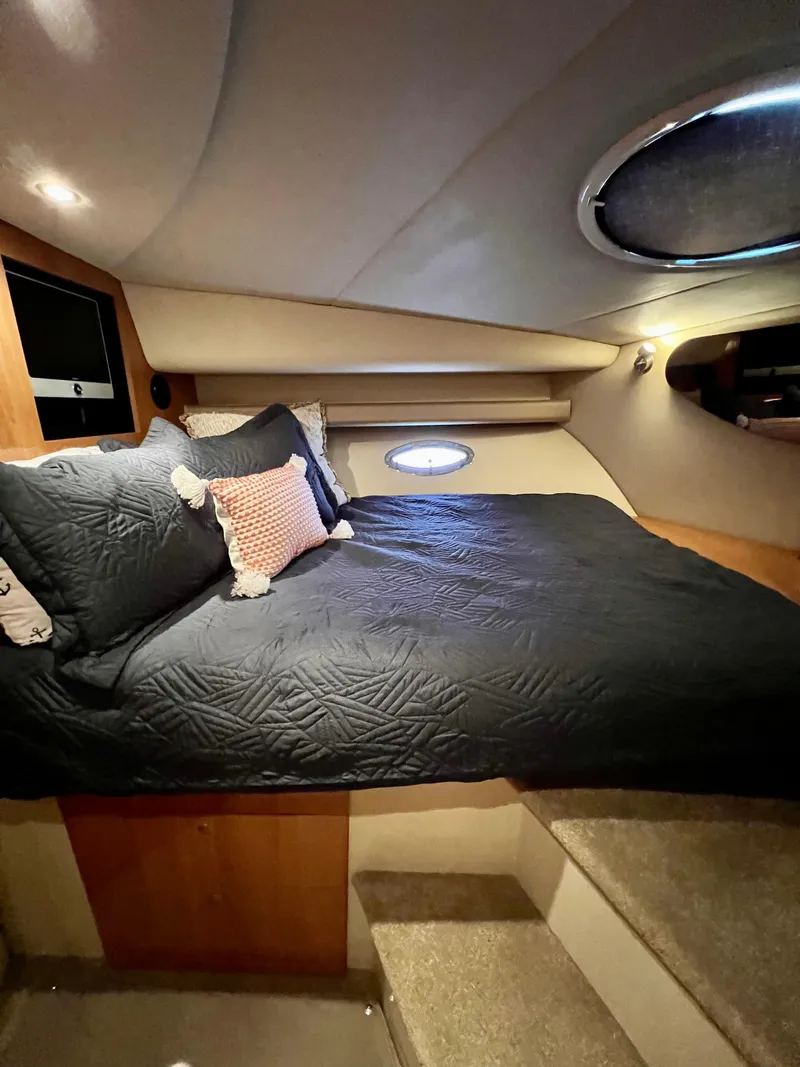 Slide: The Image of Luxurious cabin interior of 2008 Cruisers 395 Motoryacht with cozy bedding and ambient lighting. - 17