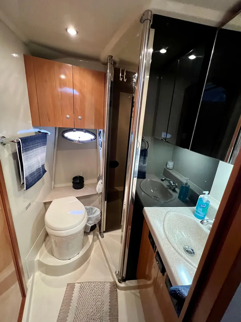 Slide: The Image of 2008 Cruisers 395 Motoryacht bathroom with modern fixtures and wood cabinetry. - 18