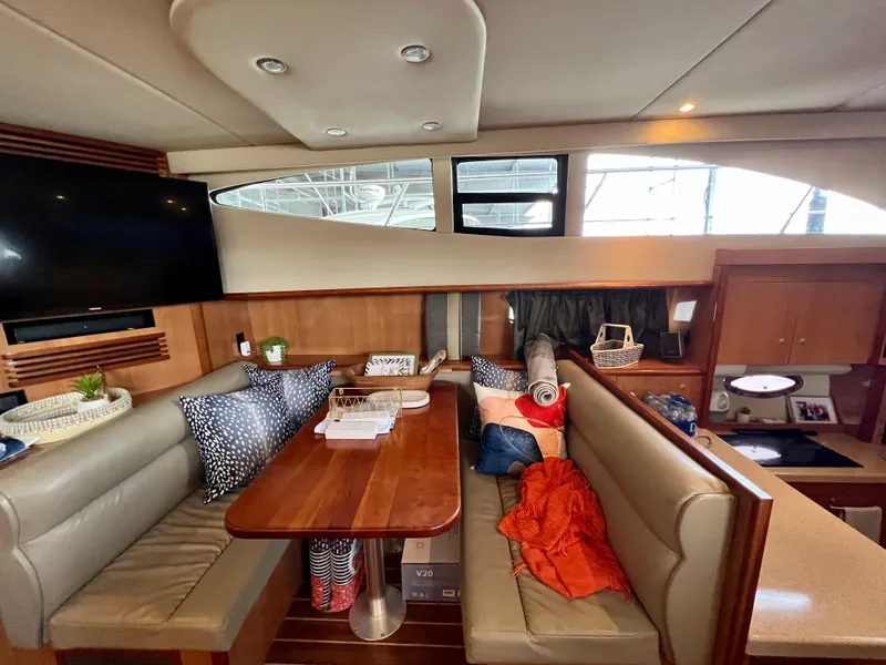 Slide: The Image of 2008 Cruisers 395 Motoryacht interior with dining area, cushions, and modern decor. - 19