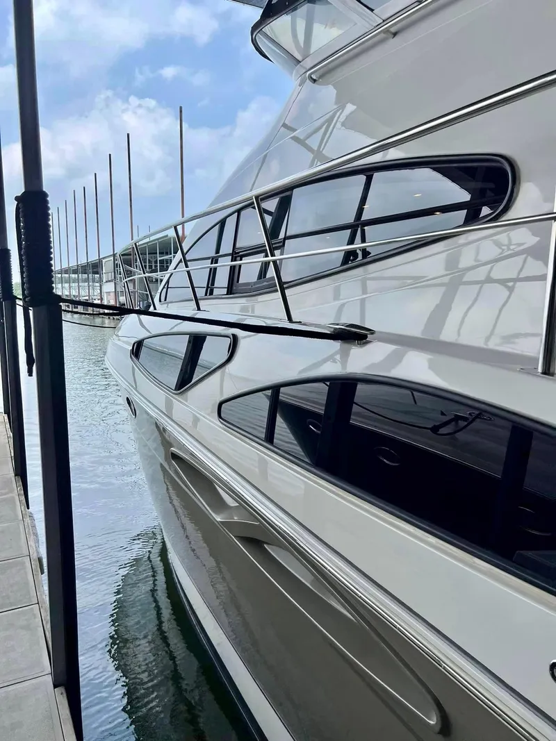 Slide: The Image of 2008 Cruisers 395 Motoryacht docked, showcasing sleek design and reflective windows. - 2