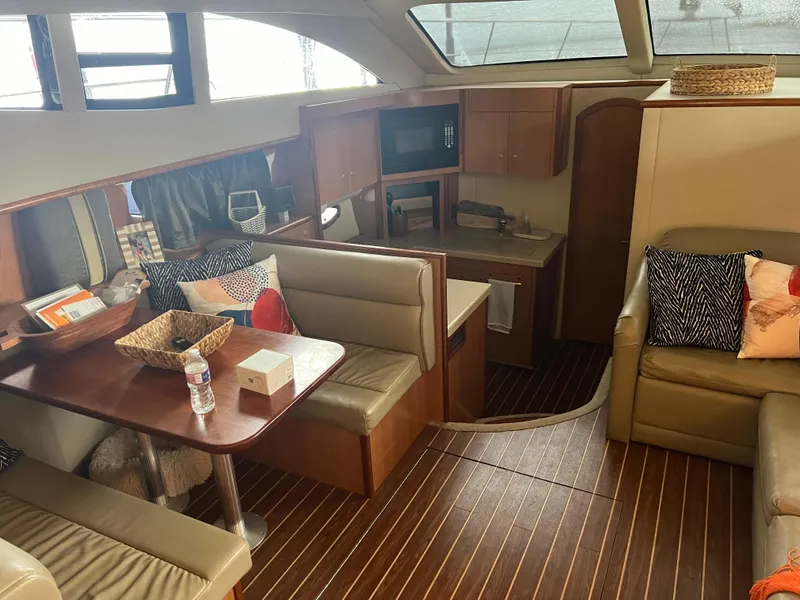 Slide: The Image of 2008 Cruisers 395 Motoryacht interior with dining area, kitchenette, and cozy seating. - 21