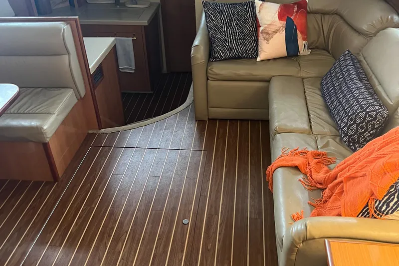 Slide: The Image of 2008 Cruisers 395 Motoryacht interior with leather seating, wooden flooring, and decorative cushions. - 24