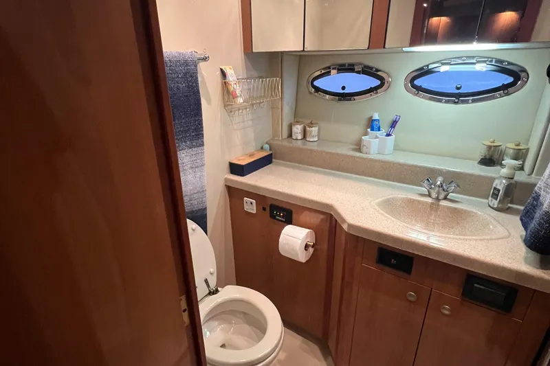 Slide: The Image of 2008 Cruisers 395 Motoryacht bathroom with sink, toilet, and porthole windows. - 29