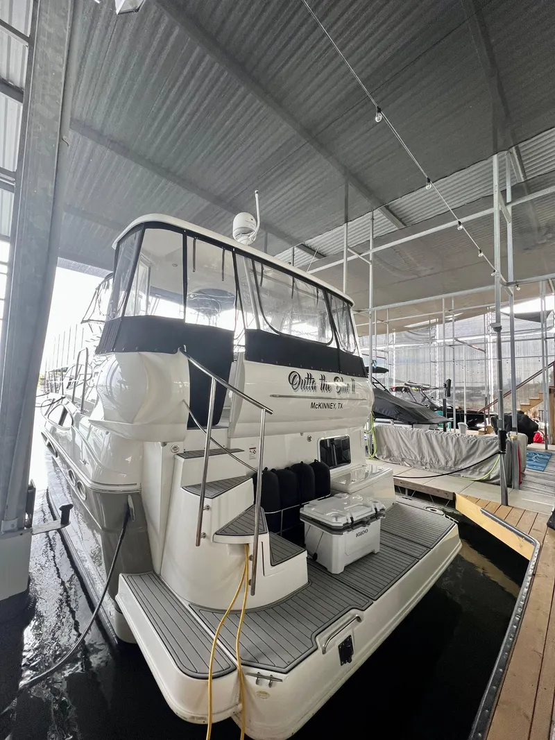 Slide: The Image of 2008 Cruisers 395 Motoryacht docked in a covered marina. - 3