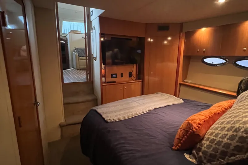 Slide: The Image of Luxurious 2008 Cruisers 395 Motoryacht bedroom with cozy bedding and elegant wood finishes. - 31