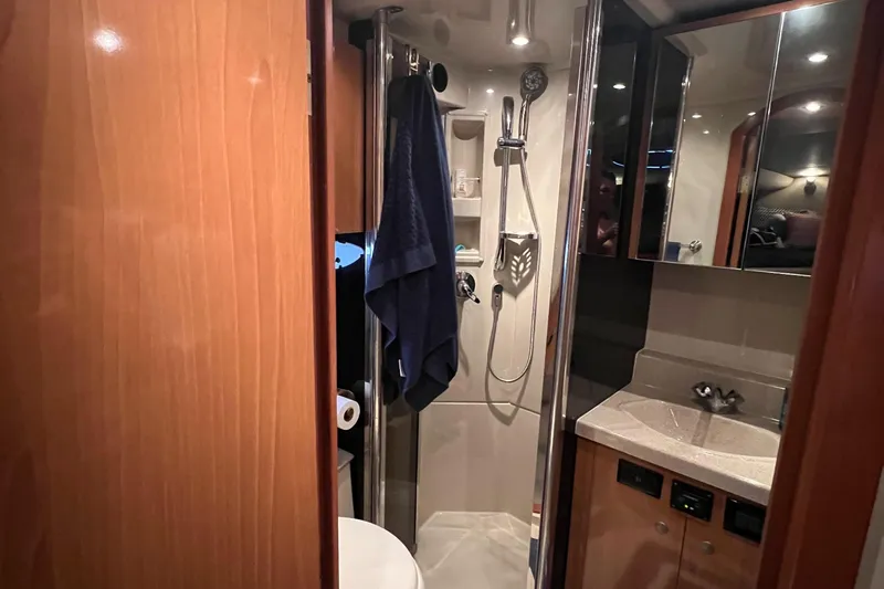 Slide: The Image of Luxurious bathroom in 2008 Cruisers 395 Motoryacht with modern fixtures and wood accents. - 32