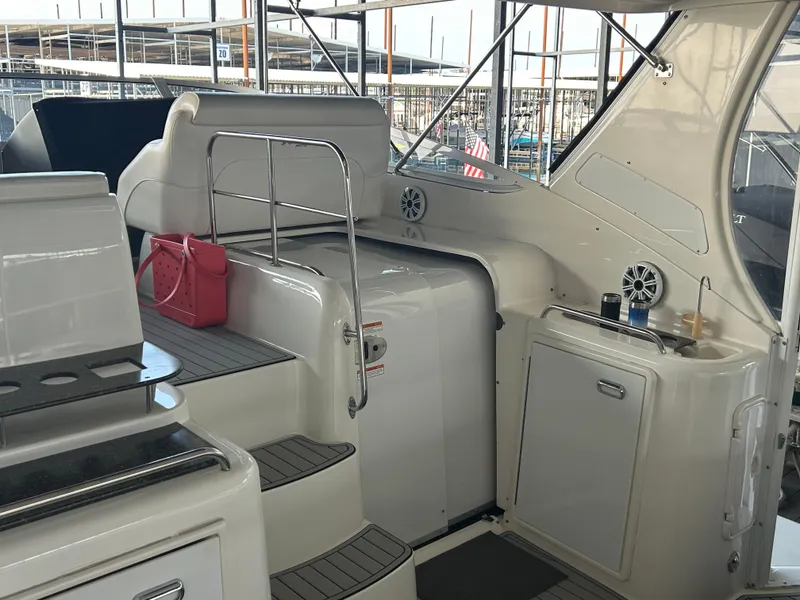 Slide: The Image of 2008 Cruisers 395 Motoryacht interior with stairs, cabinetry, and a pink bag. - 6