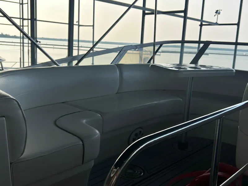 Slide: The Image of 2008 Cruisers 395 Motoryacht interior with curved seating and table, overlooking water. - 7