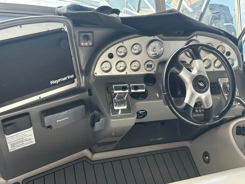 Slide: The Image of 2008 Cruisers 395 Motoryacht helm with Raymarine electronics and modern dashboard controls. - 8