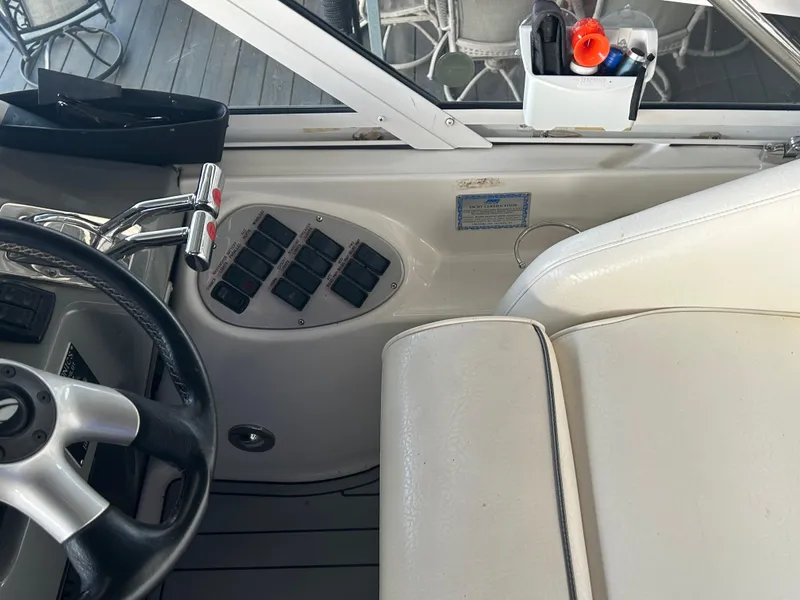 Slide: The Image of 2008 Cruisers 395 Motoryacht helm with steering wheel, control panel, and white seating. - 9