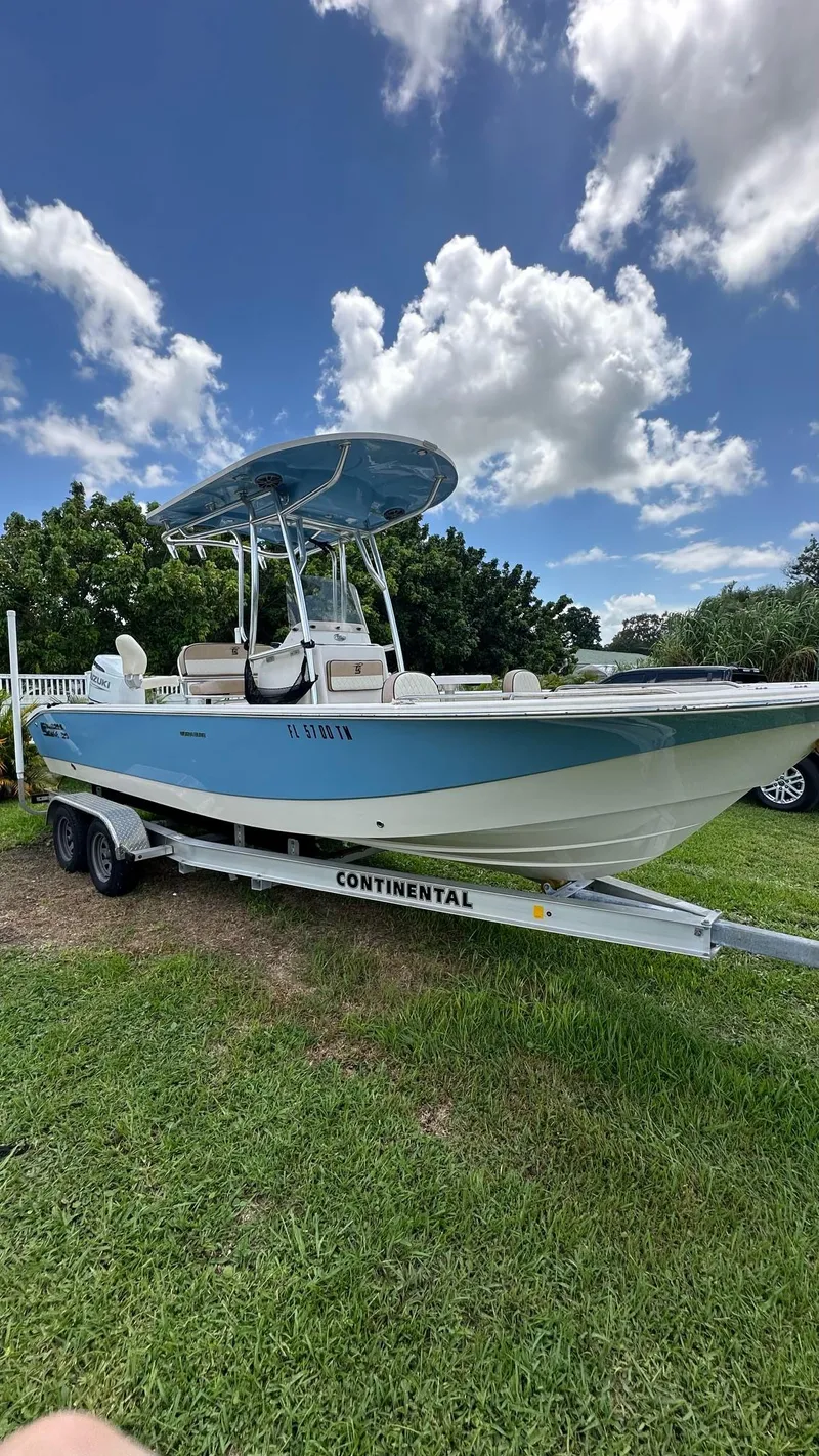 The Image of 2023 Carolina Skiff 24 Ultra Elite boat on a Continental trailer under a blue sky. - 1