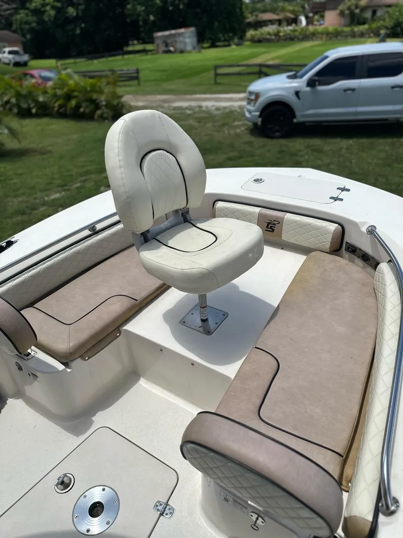Slide: The Image of 2023 Carolina Skiff 24 Ultra Elite boat interior with cushioned seating and swivel chair. - 13