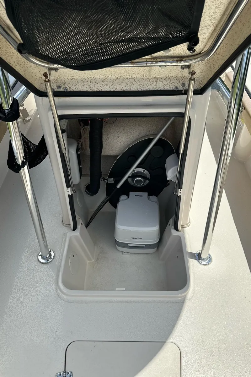 Slide: The Image of 2023 Carolina Skiff 24 Ultra Elite boat interior with storage compartment. - 17