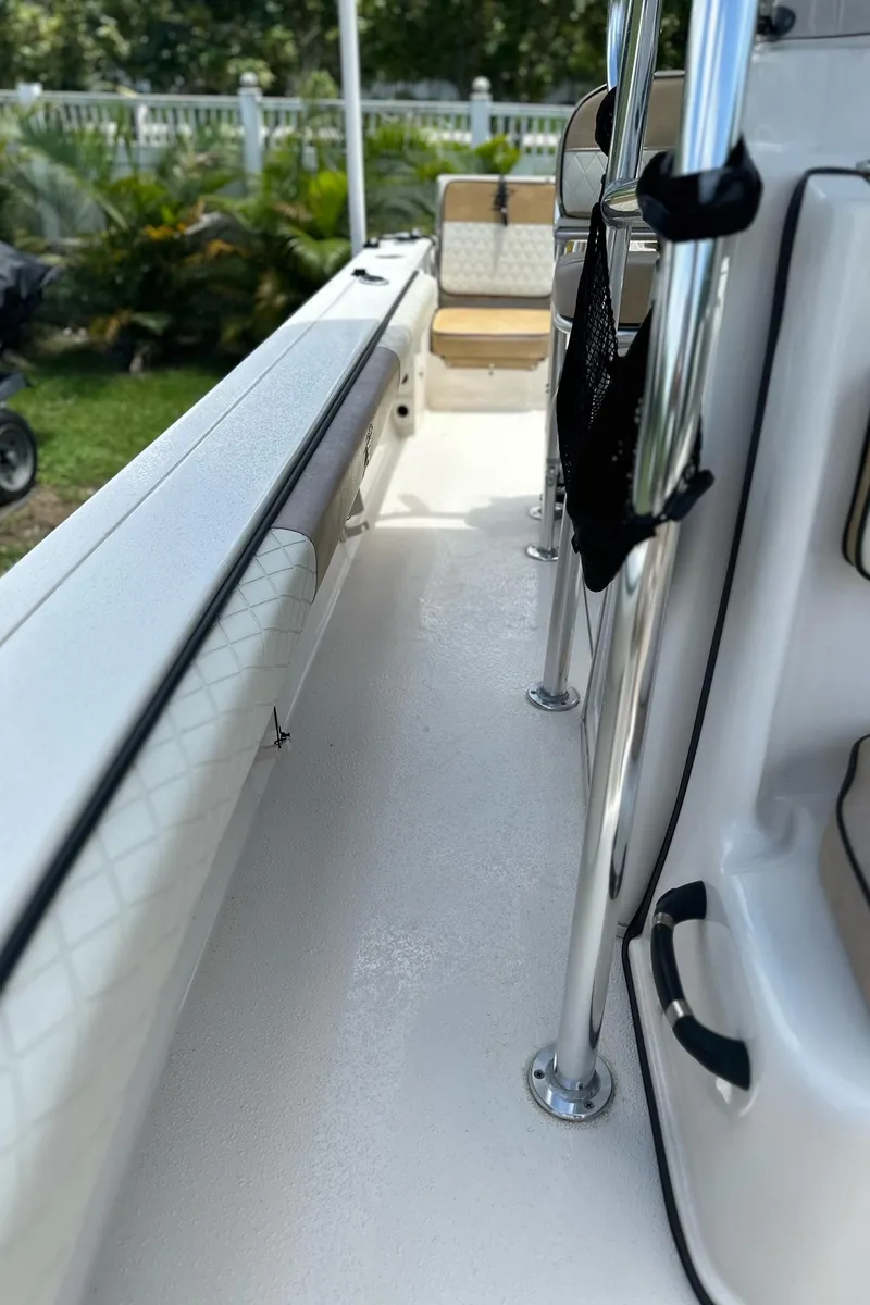 Slide: The Image of 2023 Carolina Skiff 24 Ultra Elite boat interior with seating and railing. - 18