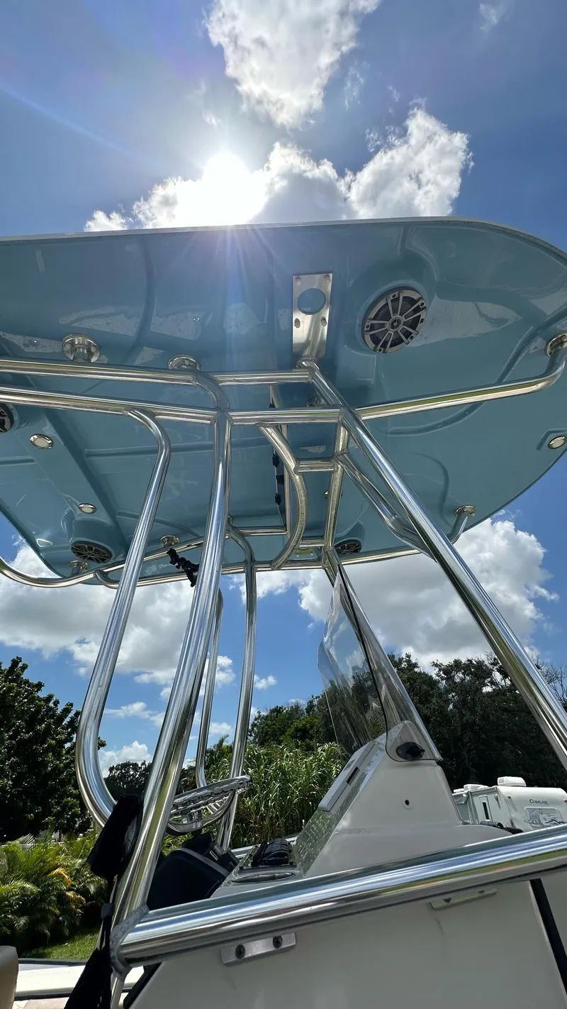 Slide: The Image of 2023 Carolina Skiff 24 Ultra Elite boat with T-top under sunny sky. - 26