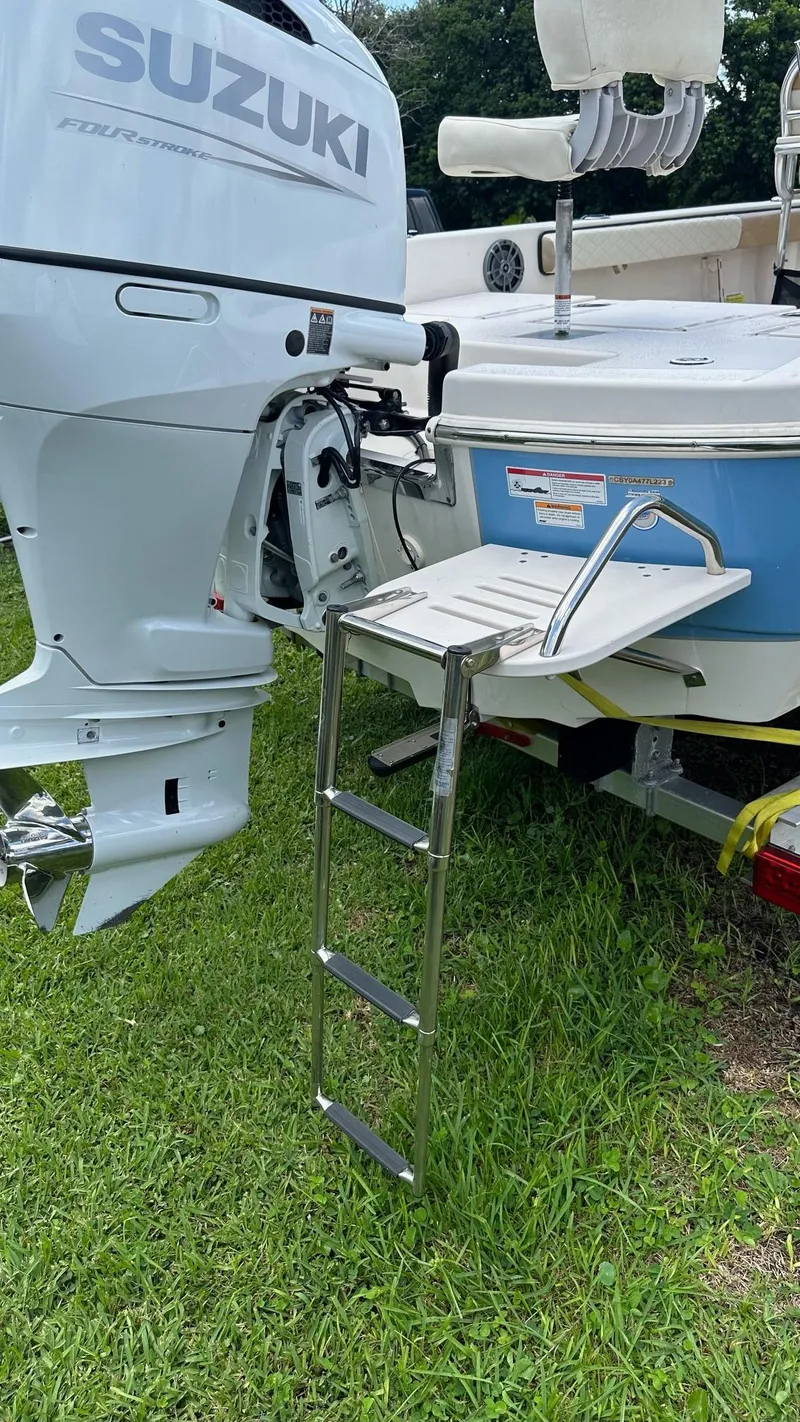 Slide: The Image of 2023 Carolina Skiff 24 Ultra Elite with Suzuki outboard motor and swim ladder. - 34