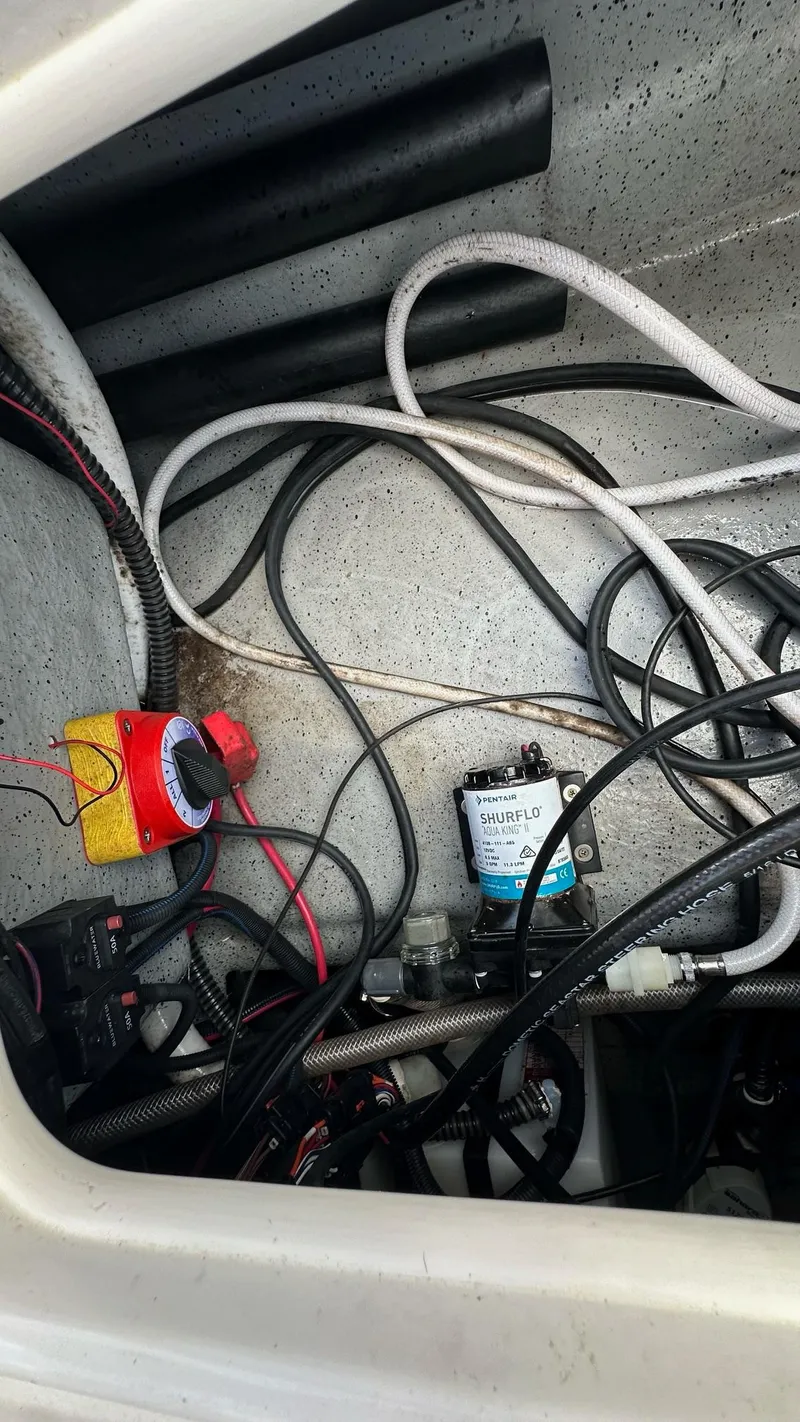 Slide: The Image of Electrical wiring and components inside a 2023 Carolina Skiff 24 Ultra Elite boat. - 35