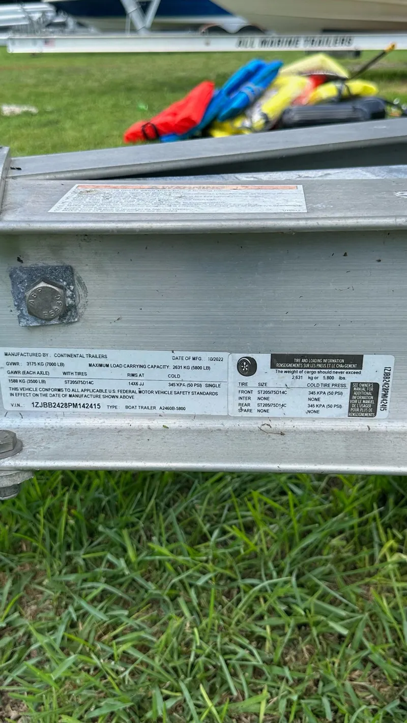 Slide: The Image of Close-up of a 2023 Carolina Skiff 24 Ultra Elite boat trailer label. - 38