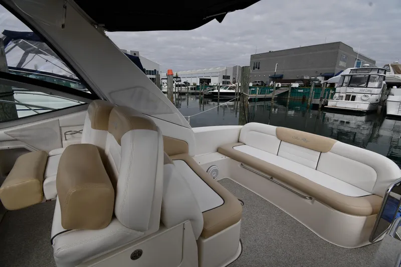 Slide: The Image of 2009 Sea Ray 330 Sundancer interior with beige seating, docked at marina. - 19