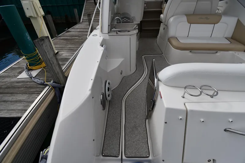 Slide: The Image of 2009 Sea Ray 330 Sundancer boat interior with seating and dock view. - 22