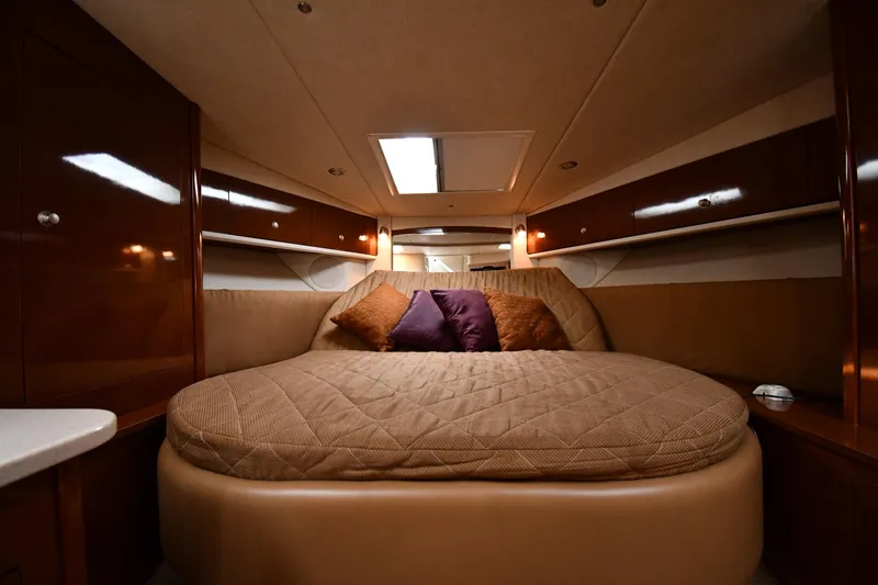 Slide: The Image of Luxurious cabin interior of 2009 Sea Ray 330 Sundancer with cozy bedding and ambient lighting. - 25