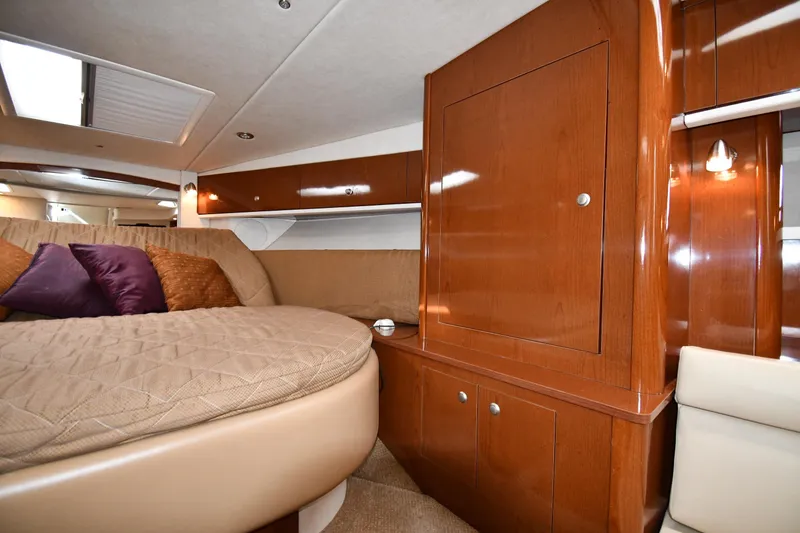 Slide: The Image of Luxurious interior of 2009 Sea Ray 330 Sundancer with wood finish and cozy bedding. - 26
