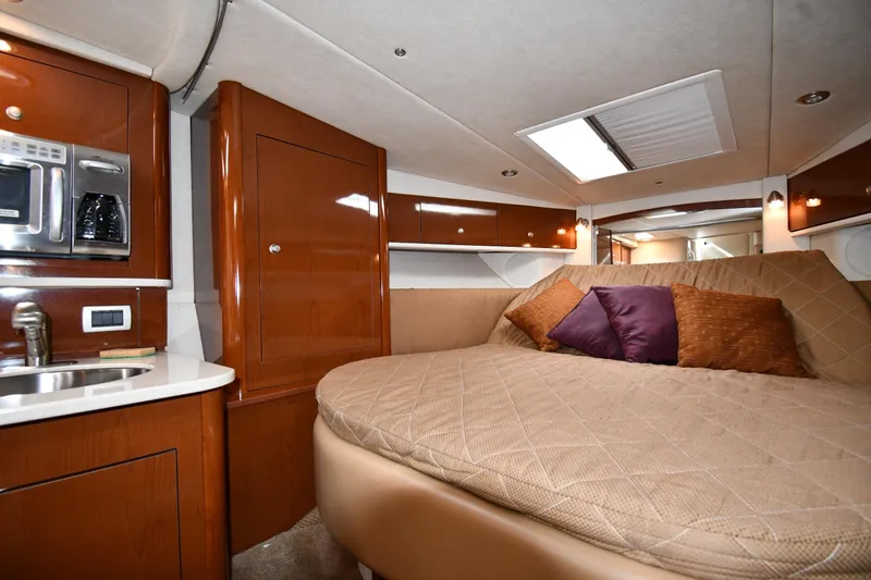 Slide: The Image of Luxurious interior of 2009 Sea Ray 330 Sundancer with cozy bed and kitchenette. - 27