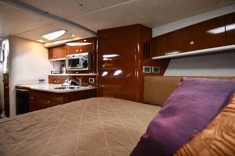 Slide: The Image of Interior of 2009 Sea Ray 330 Sundancer yacht with kitchen and cozy bed. - 28