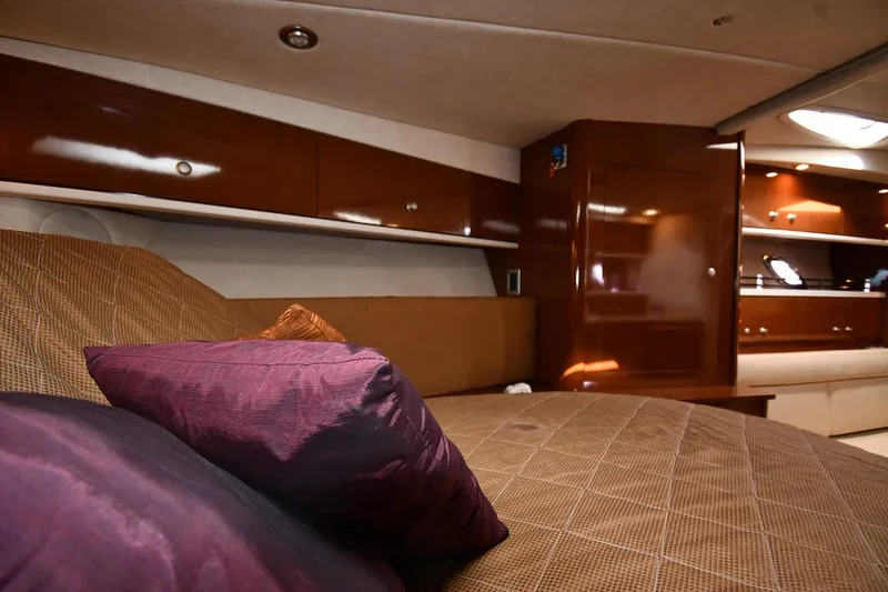 Slide: The Image of Luxurious interior of 2009 Sea Ray 330 Sundancer yacht with plush bedding and wooden cabinetry. - 29