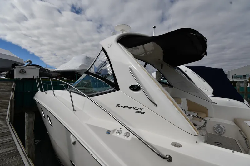 Slide: The Image of 2009 Sea Ray 330 Sundancer docked under cloudy skies. - 3