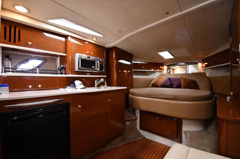 Slide: The Image of Luxurious interior of 2009 Sea Ray 330 Sundancer yacht with kitchen and cozy bed. - 31